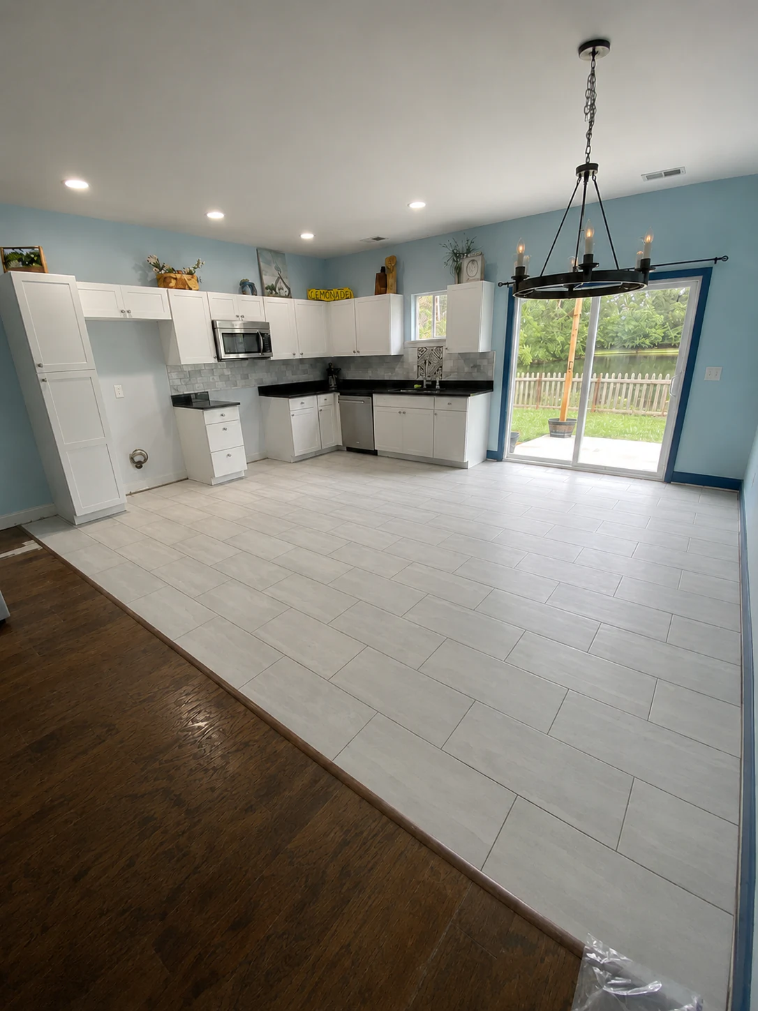 Room after wood flooring installation by Paez And More